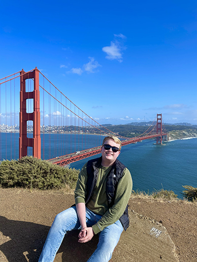 person seated in front of Golden Gate Bridge