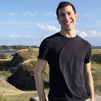 man standing in front of hay bales
