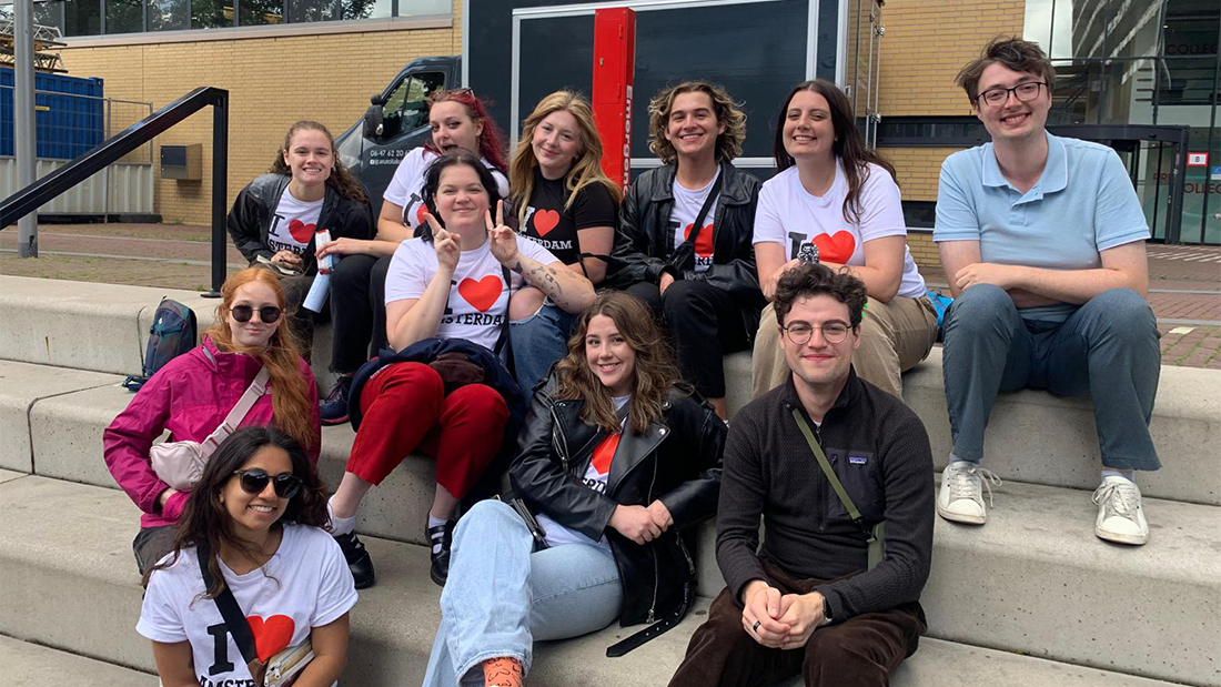 Group of students seated on steps outside building