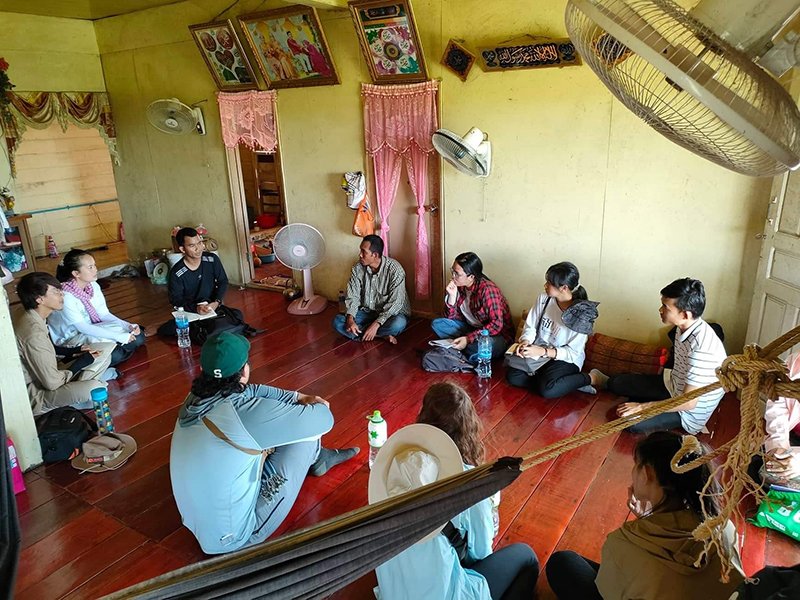 People seated on a floor in a circle