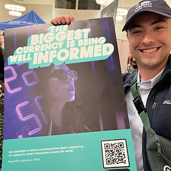 Jack holding a sign promoting SpotlightNews