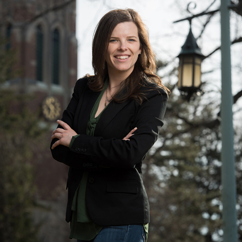 Kelly Tebay standing by an MSU lantern