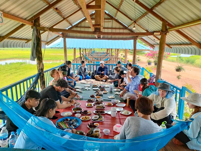 People seated in a circle sharing a meal