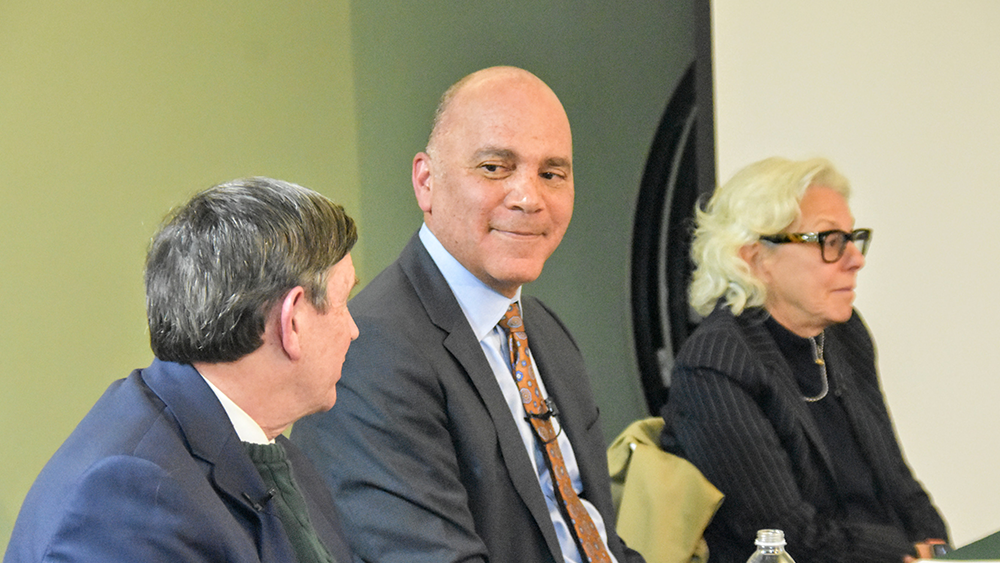 Three panelists at a table
