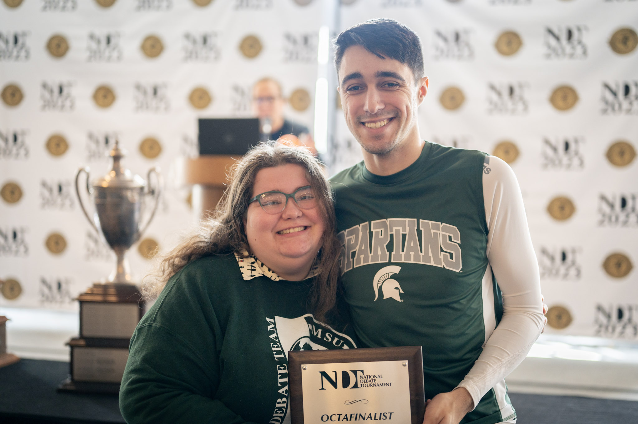 Piper and Nate holding a plaque