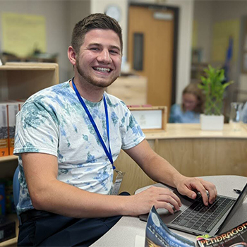Man sitting at a desk with a laptop computer