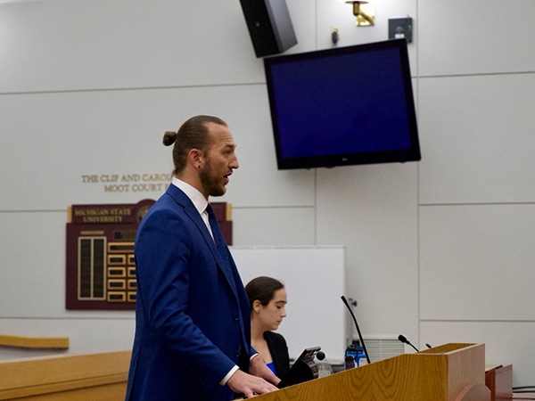 Nicholas Langenberg arguing in a courtroom.