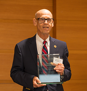 J.D. Windgarden holding Lifetime Achievement in Teaching Award