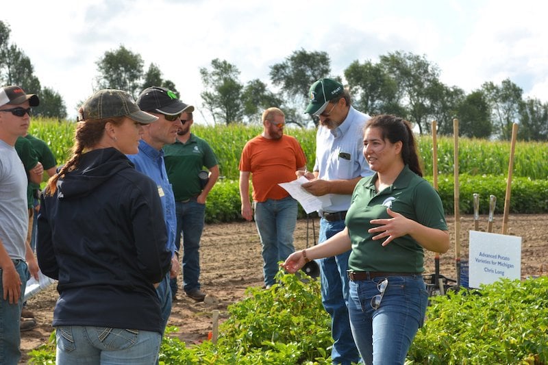 Researchers and growers in a field 