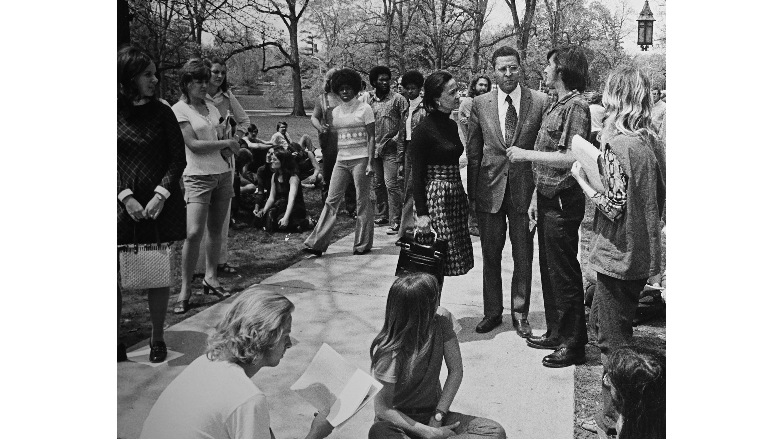 Wharton speaking with students on campus