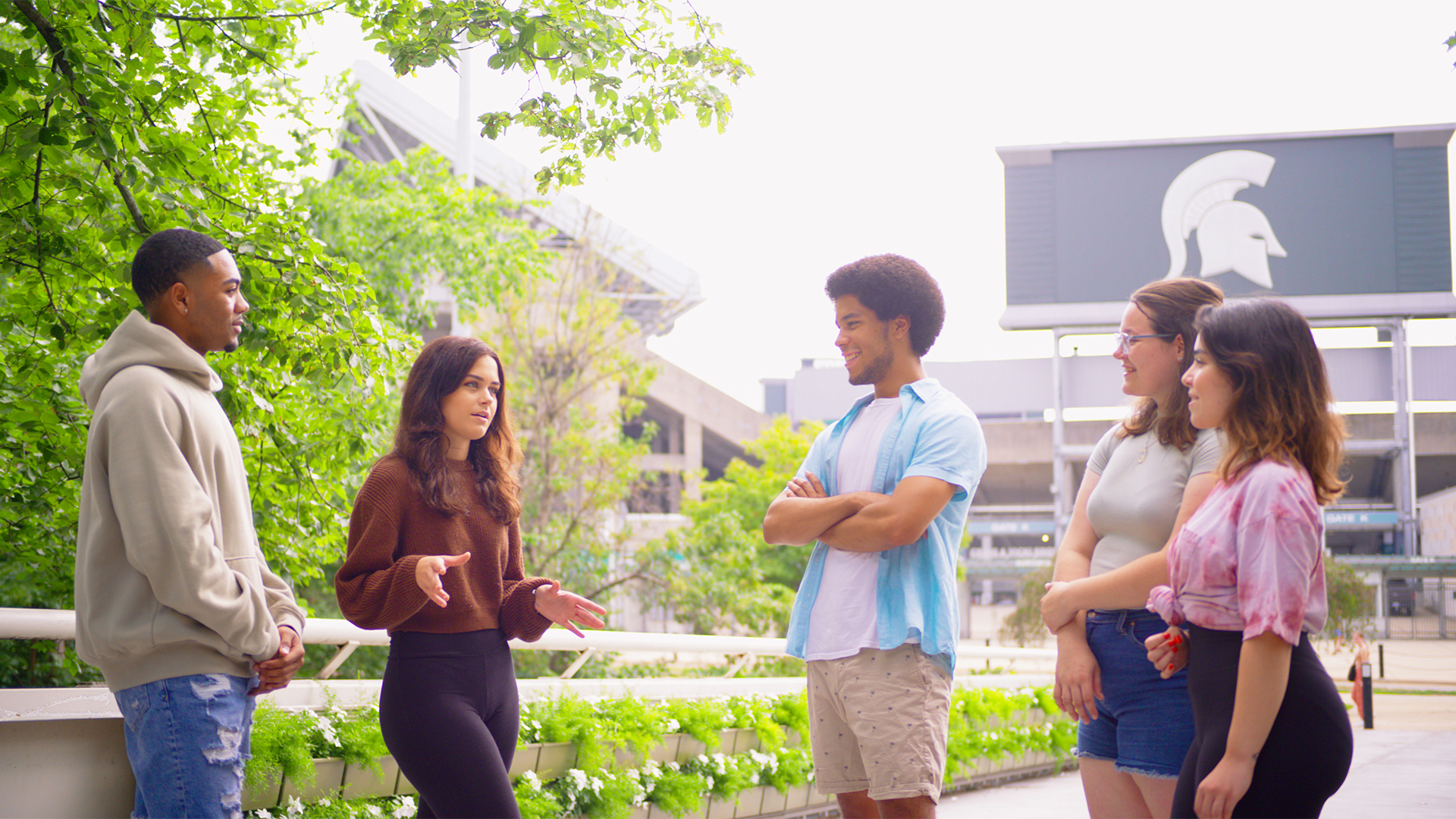 Students gather on bridge in front of Spartan Stadium