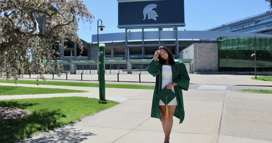 Alumna Holly Pringle in front of the Spartan Stadium.