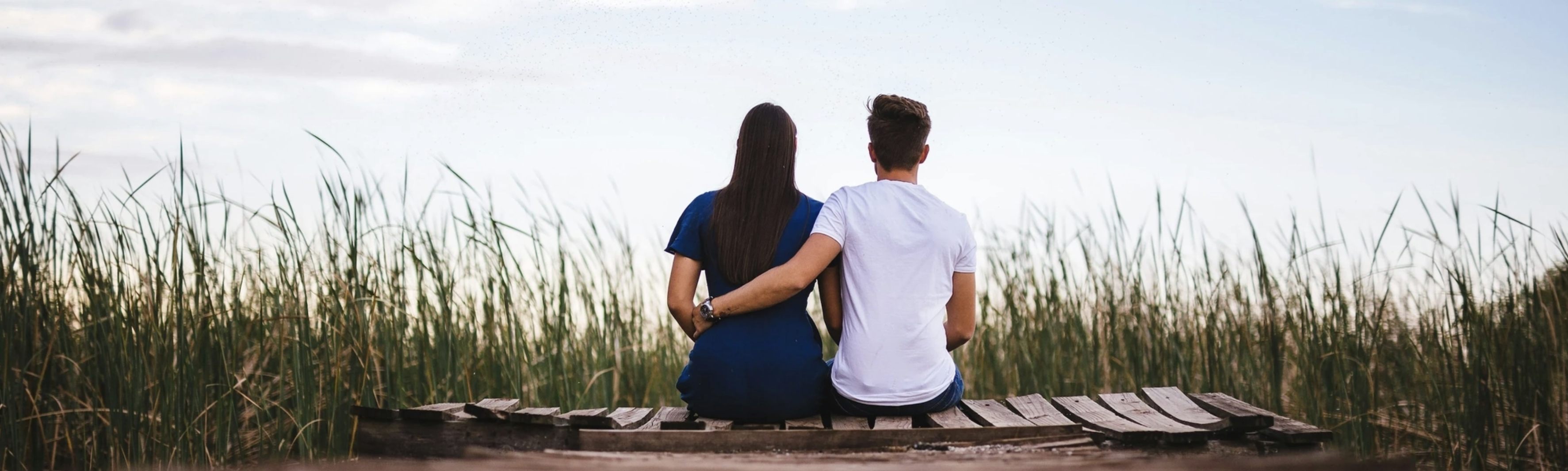 Two adults sit together facing away from the camera.