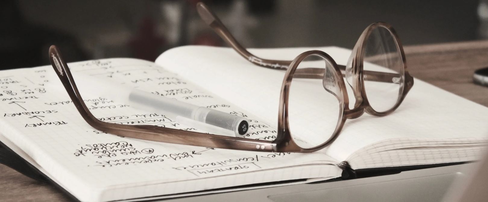 a glass sits on top of a notebook