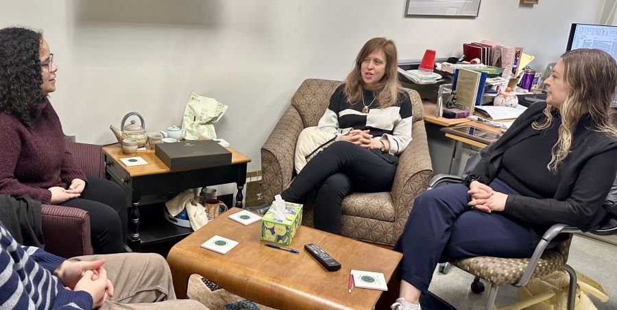 People chat sitting in chairs.