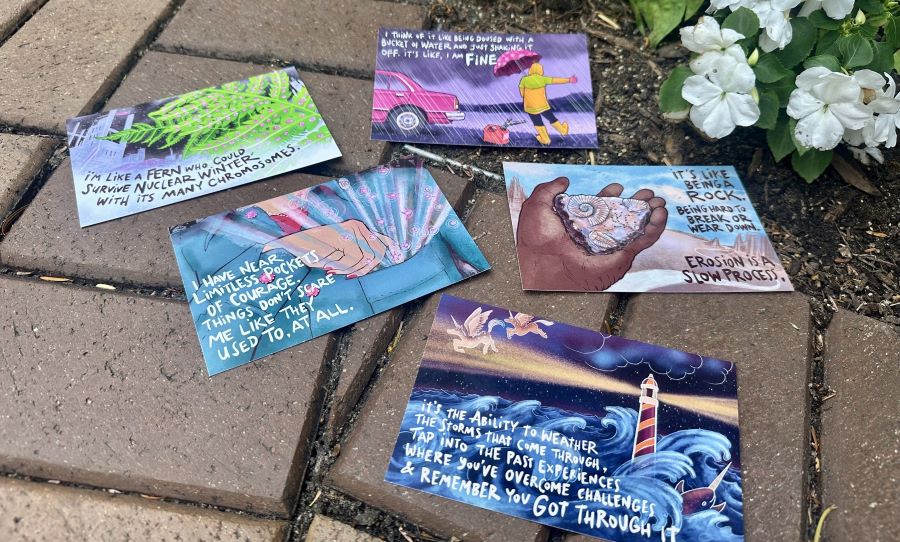 Postcards laying on bricks.