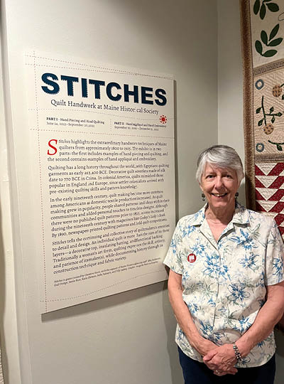 MSU alumna Christine Force stands in front of a sign titled