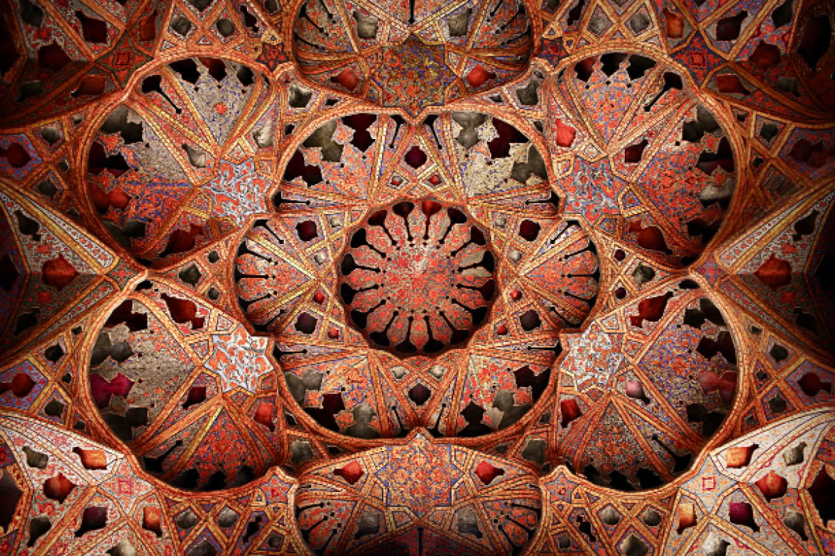 Close-up detail of a typical fresco at a plaster work ceiling in a historic Persian building using the Persian and Islamic architectural style and decoration.