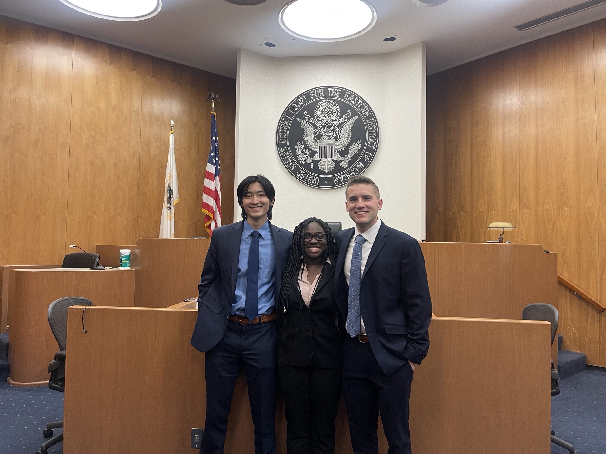 A group of three MSU Law students smiling at the camera.