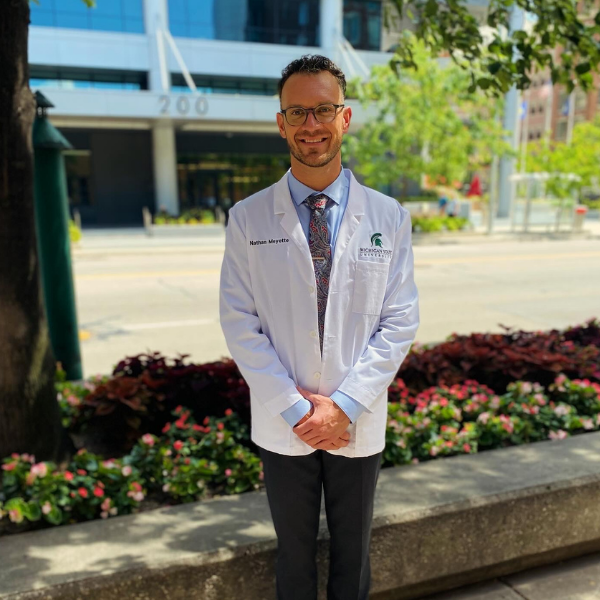 Nathan Meyette wearing MSU CHM white coat