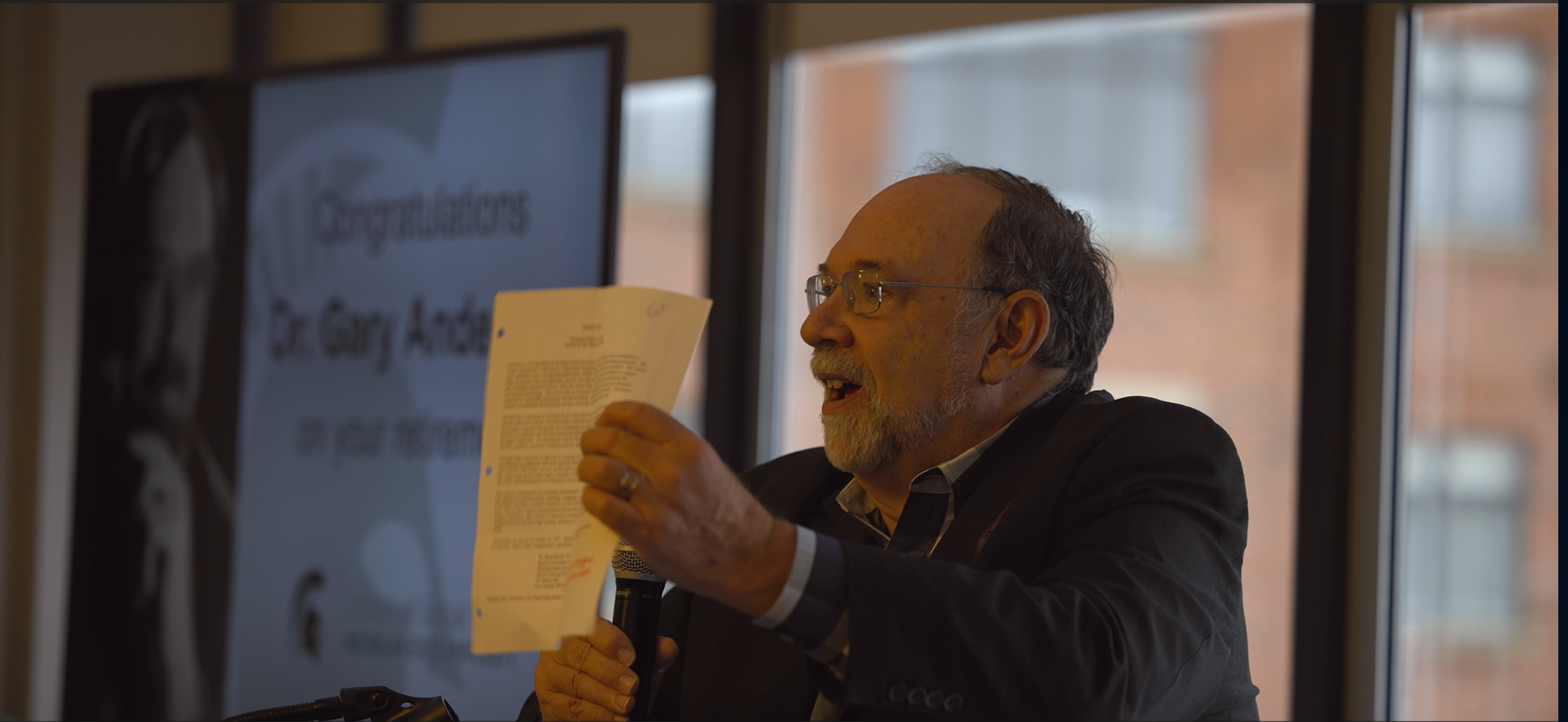 Former faculty member and director of the MSU School of Social Work Gary Anderson delivering a speech at a university event.