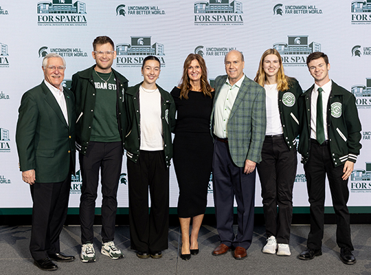Greg and Dawn Williams pose with students and staff at Breslin Center