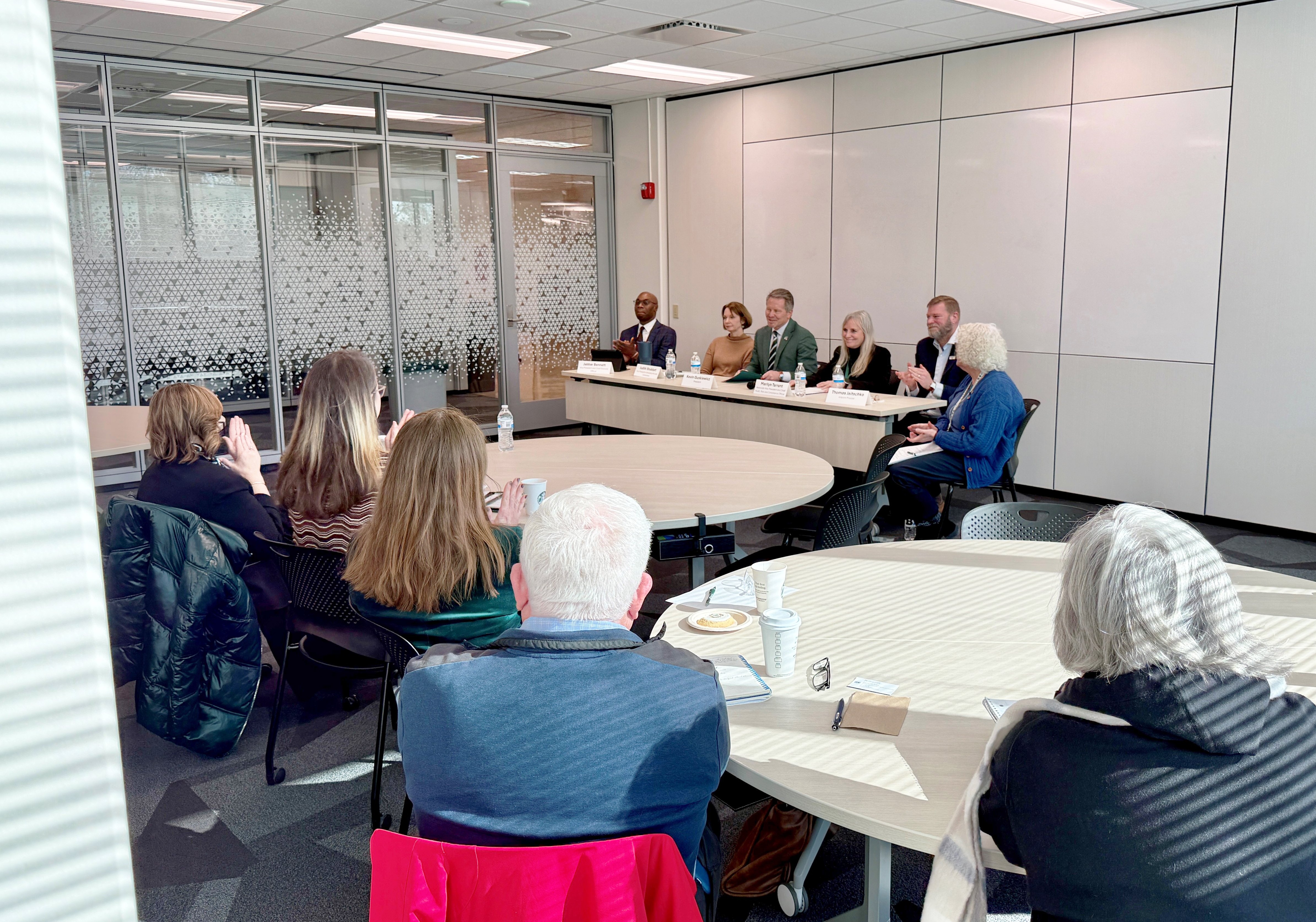 President Kevin M. Guskiewicz, Ph.D., and other university leaders sit at a table at the front of a room to answer questions during the Leadership Panel event during Ethics Week 2025.