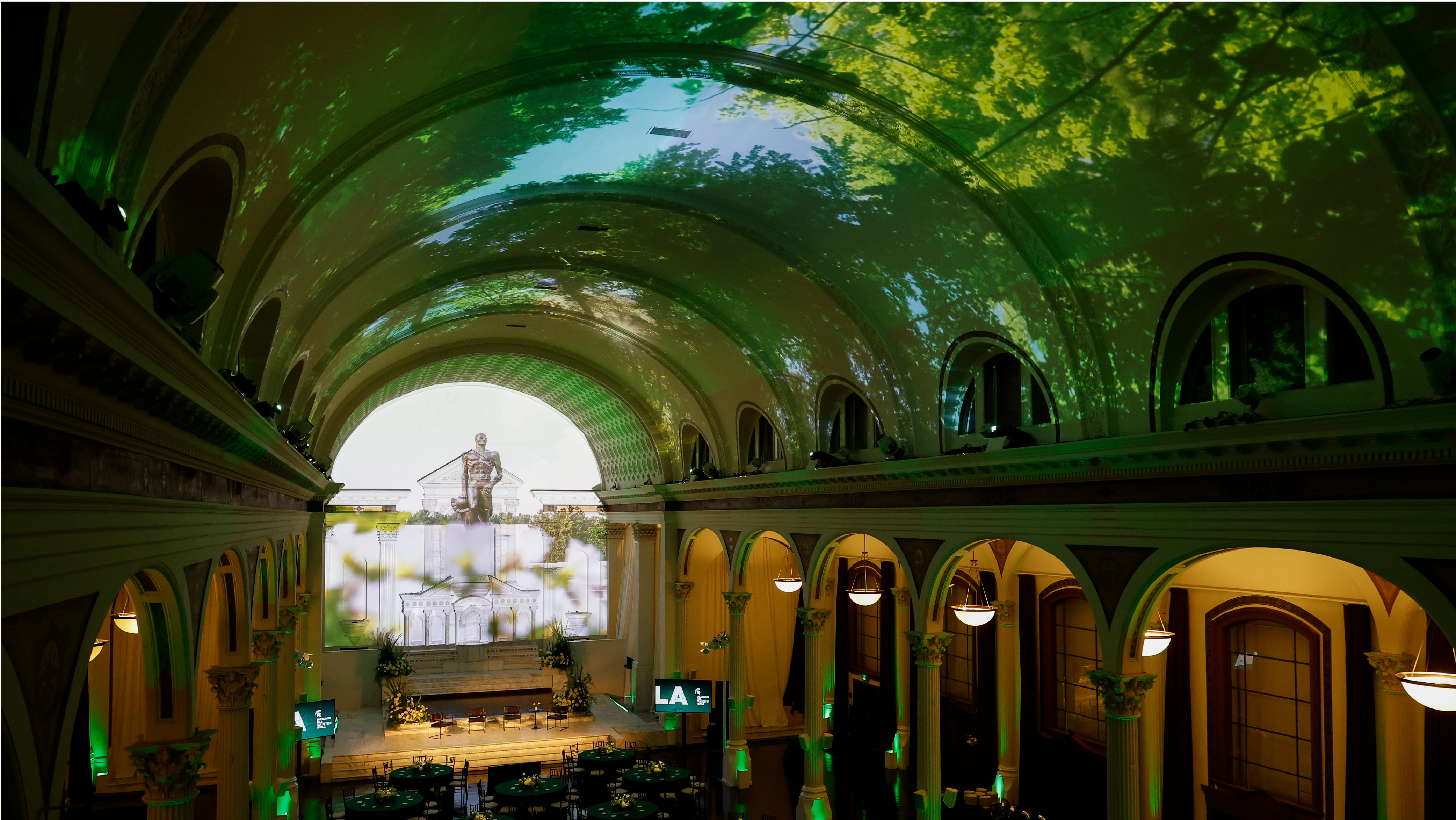 Image of the event space for the LA momentum event featuring projections ofc campus trees and the Spartan statue 