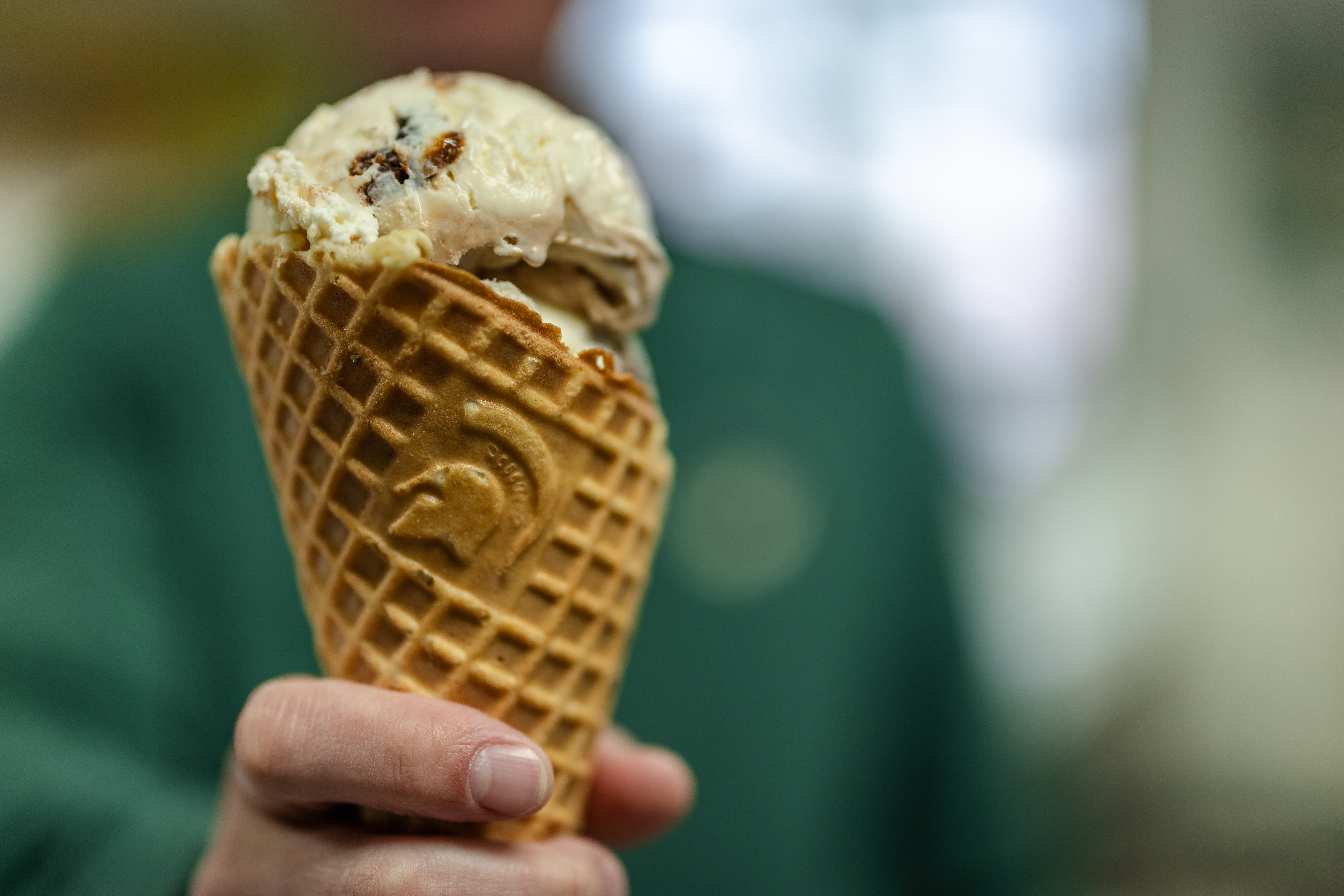 A scoop of Far Better Swirl'd, a new Dairy Store flavor celebrating the campaign, Uncommon Will. Far Better World. on a waffle cone. 