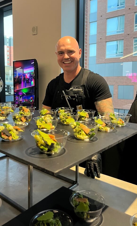 Joseph VanWagner, '09, prepares food as a guest of honor at the MSU Museum's Ascent Act I gala.