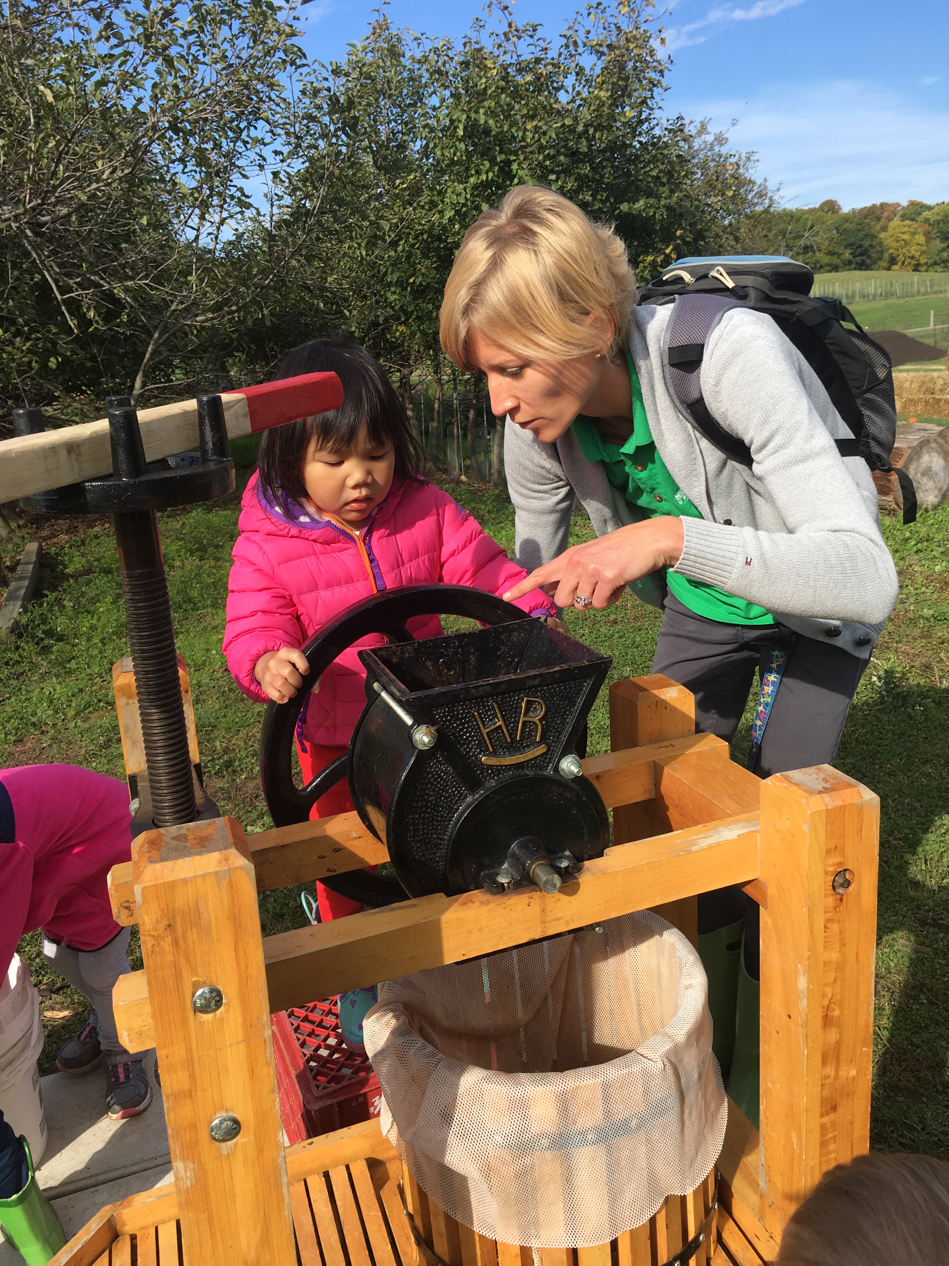 Alumna Brooke Larm works with a young child at Tollgate Farm in Novi Michigan. 