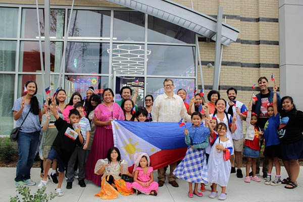 A group holding the Philippines flag outside of the Klawsome, a claw-machine arcade in Novi.