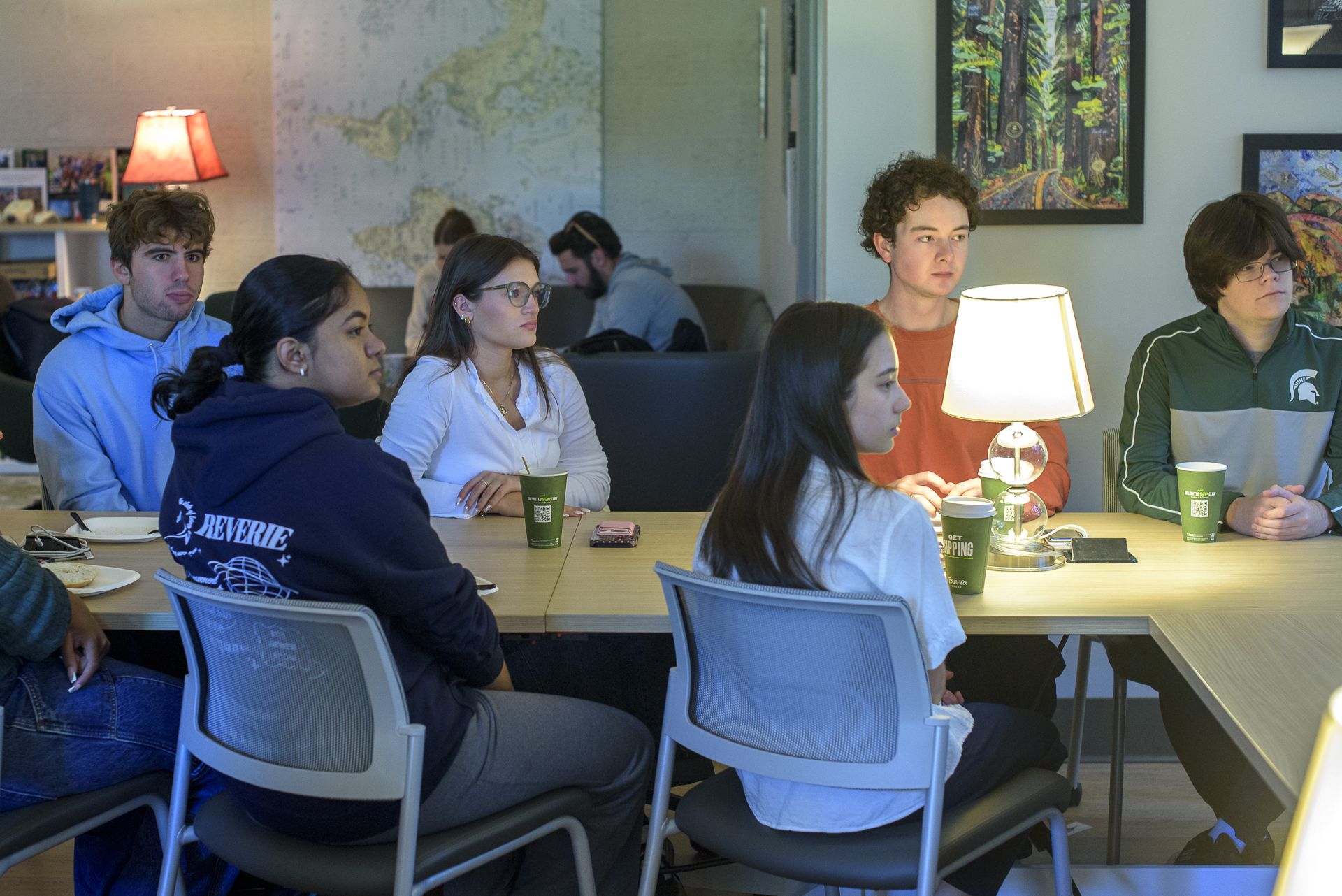 Students in the MSU Berkey Hall Social Science Scholars common room listening to a presentation.