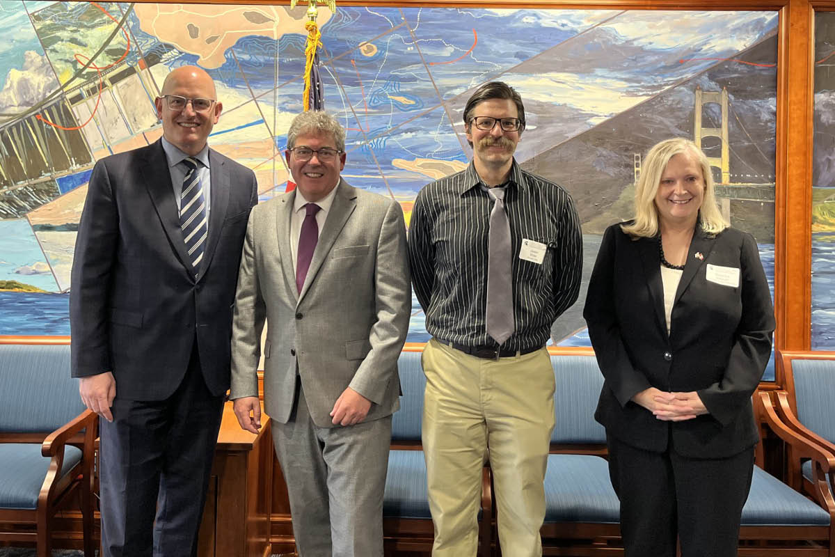 Professor Jason Miller poses for a photo with panelists following a June 2025 Canada Connect Policy Forum. Alongside him are Drew Dilkens, mayor of Windsor, Ontario; Colin Bird, consul general of Canada in Detroit; and Rebecca Malouin, director of the Canadian Studies Center. 