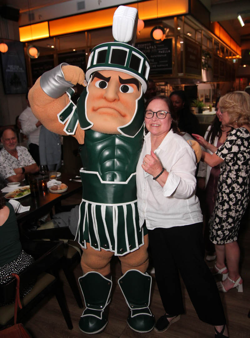 MSU alumna Renee Greening poses with Sparty.
