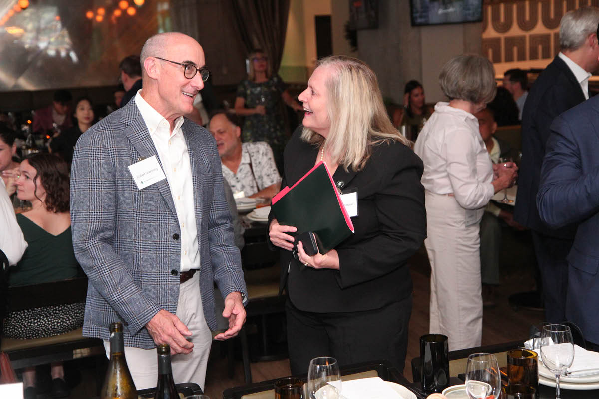 MSU alumnus Robert Greening laughs and talks with Canadian Studies Center Director Rebecca Malouin.