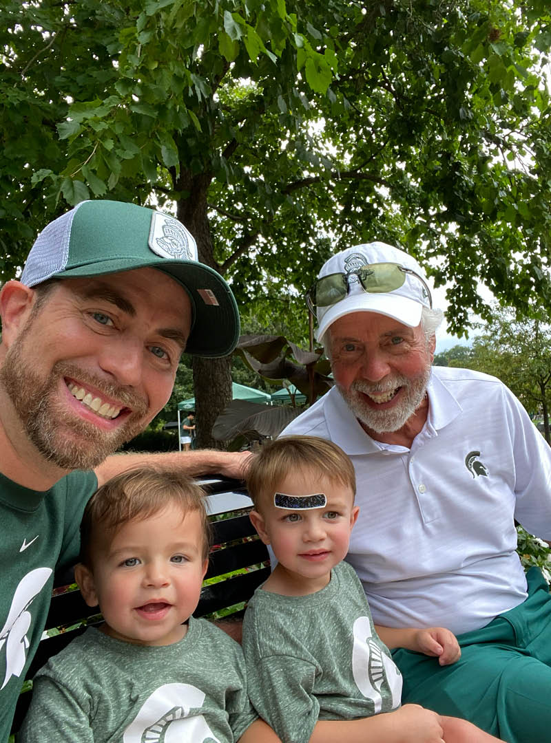 A outdoor selfie in Spartan gear showing three generations of the Bearance family with Jeff Bearance, his father Philip, and his two oldest sons.