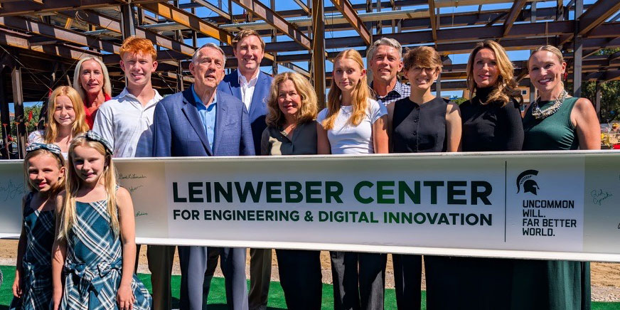 The Leinweber family, pictured with a construction beam that will become a part of the soon-to-be-completed facility that bears their name.