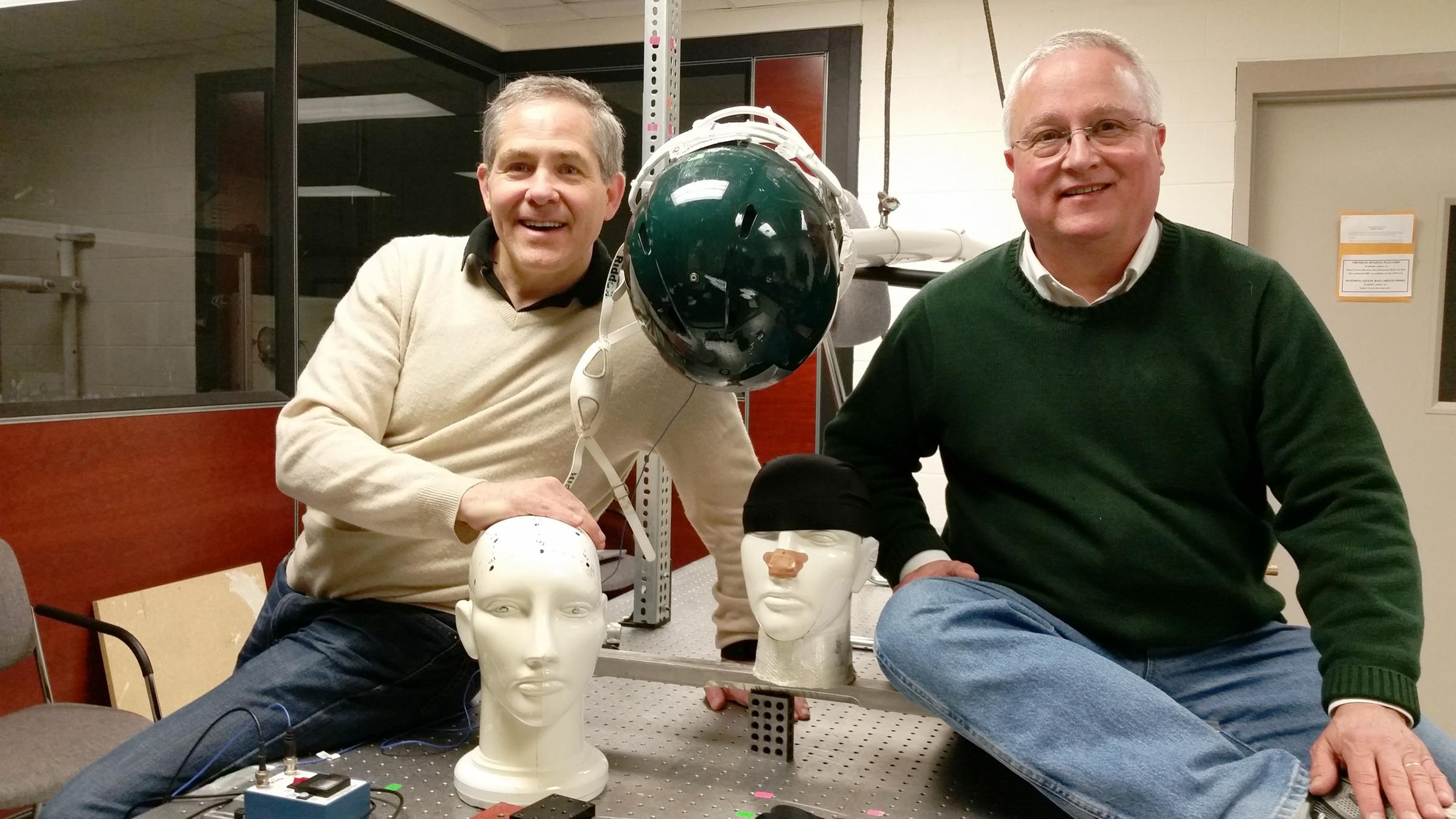 Gary Blanchard and Marcos Dantus with the headbands meant to help limit football injuries.