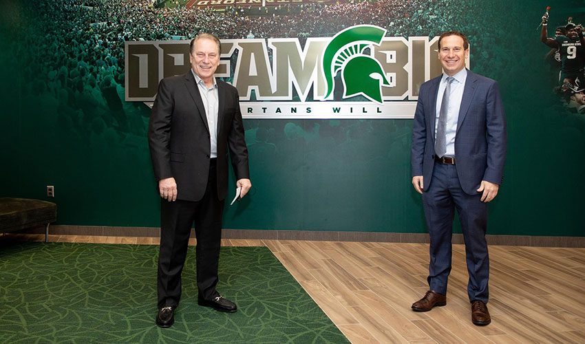 tom izzo and mat ishbia stand socially distanced in the MSU athletics offices 
