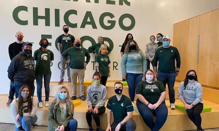 group of Chicago Spartans posing in masks after their service project