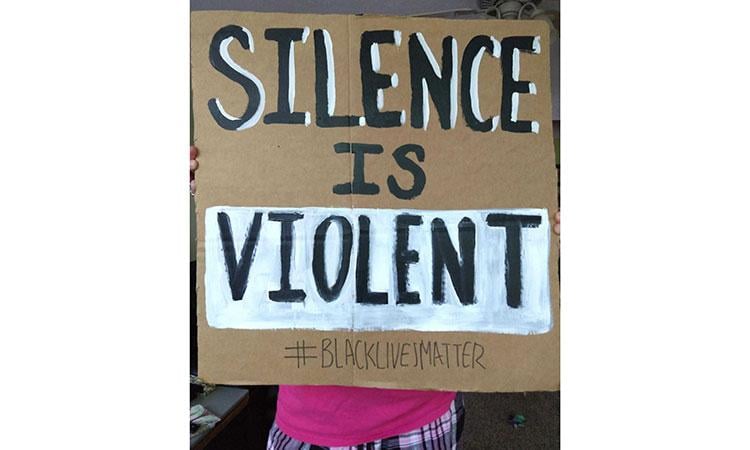 a black lives matter poster that reads: silence is violent
