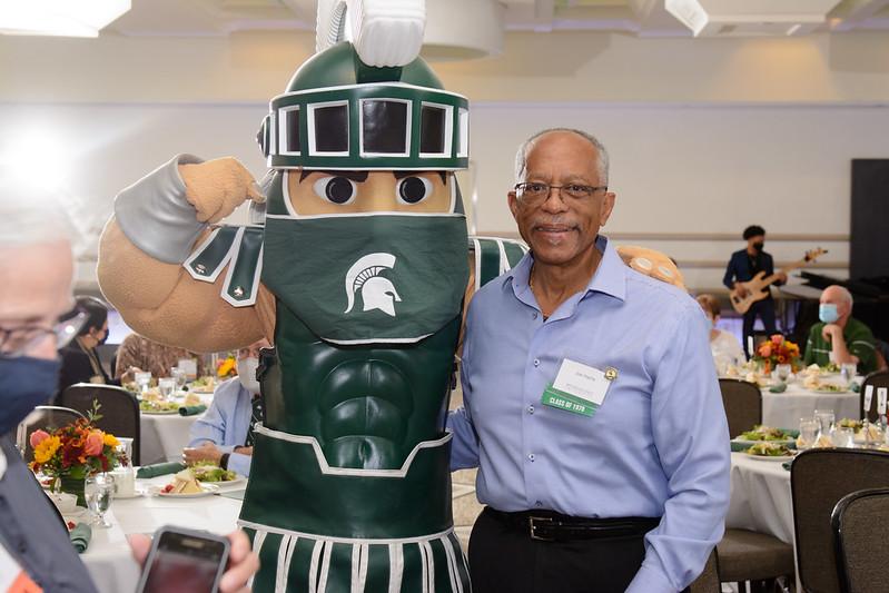 Sparty posing with an MSU alumnus