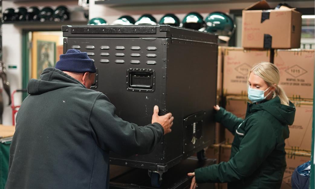 equipment team members move gear.