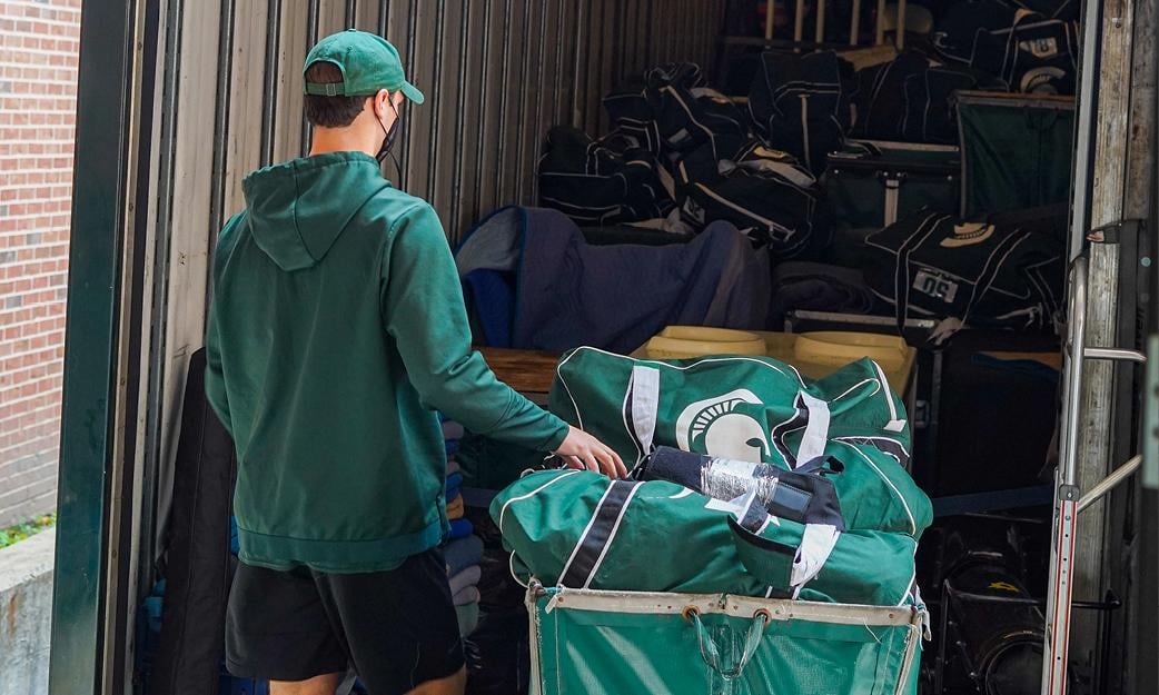 equipment team members move gear.