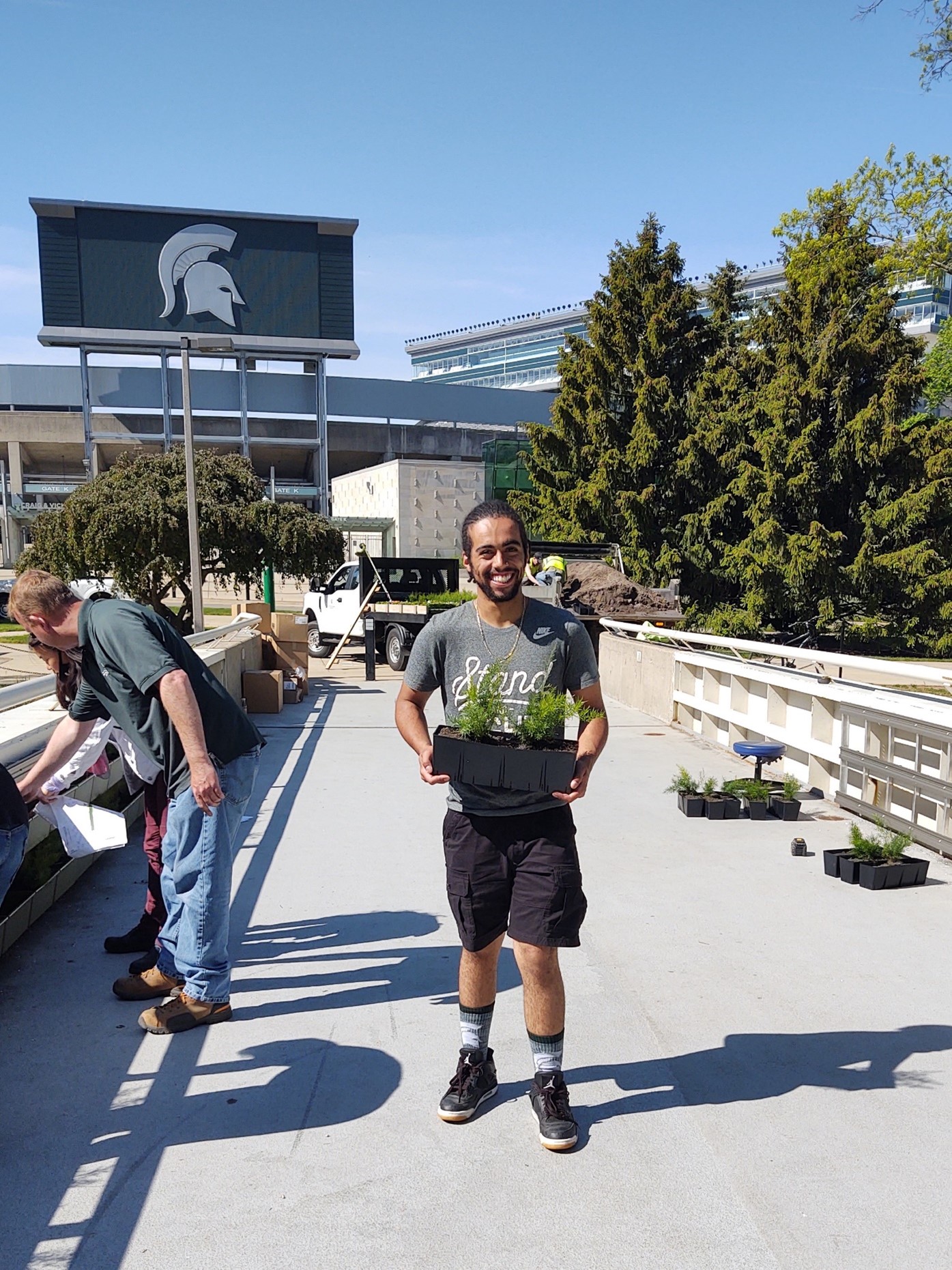 Kevin Hayes (Political Science, ’22) standing in front of green wall