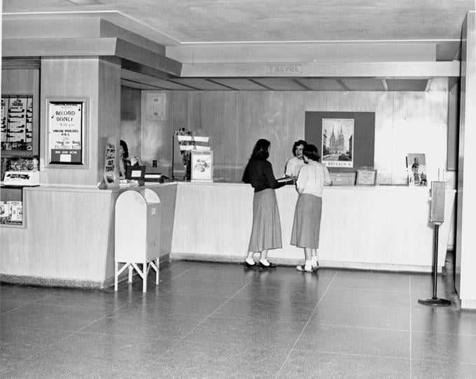 Two women book a trip at the Union's travel desk, 1949. 