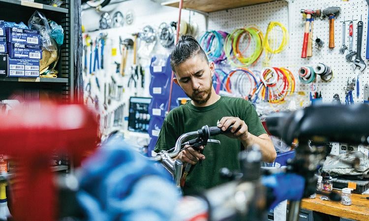 Mechanic servicing a bicycle
