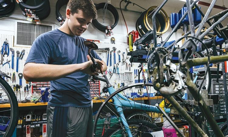 Mechanic working on bicycle handlebars