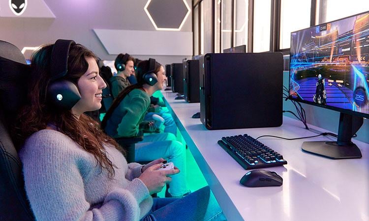 Students play PC-based games on a line of desktop computers.